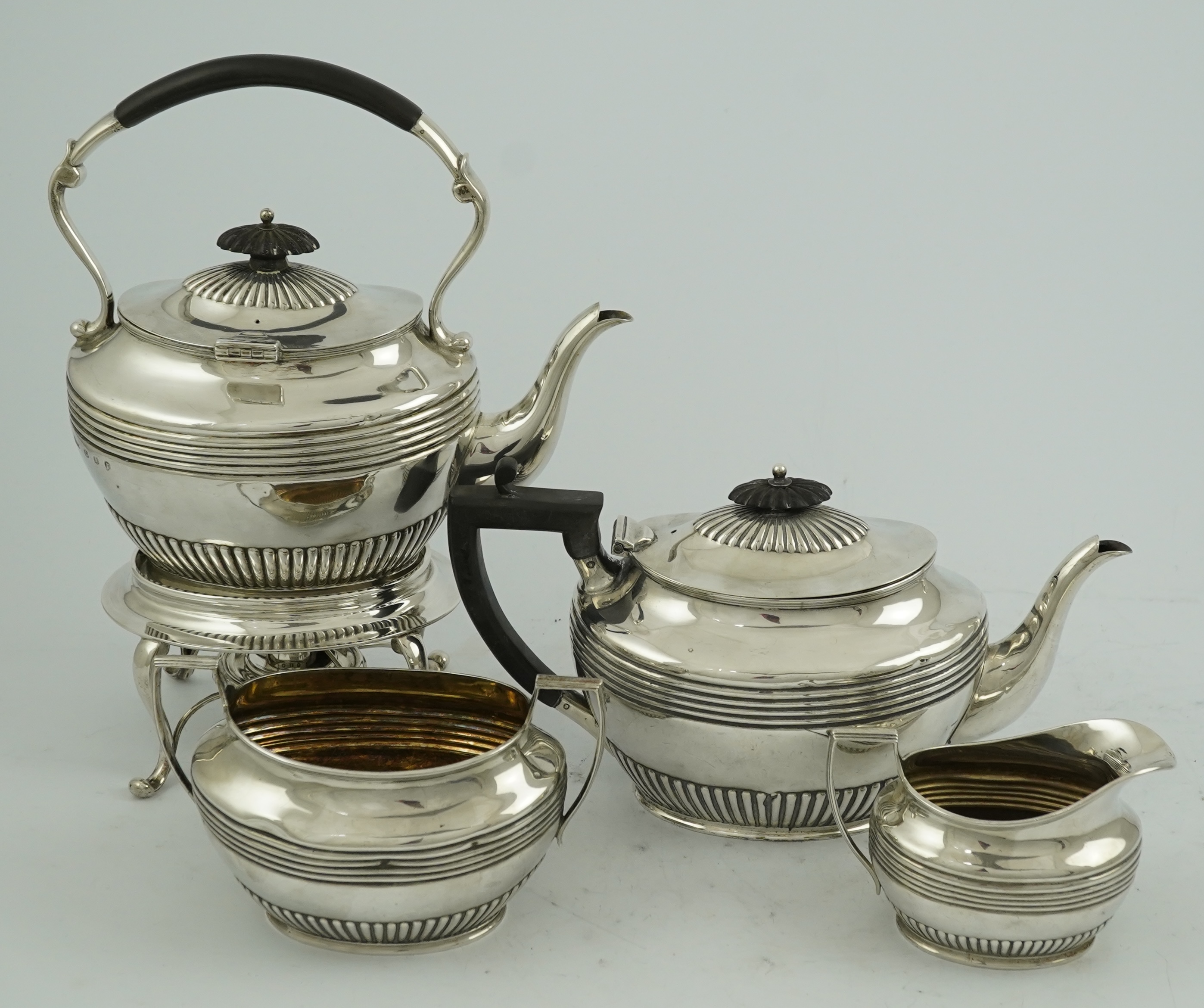 A matched Edwardian Scottish four piece demi fluted oval silver tea service by Wilson & Sharp